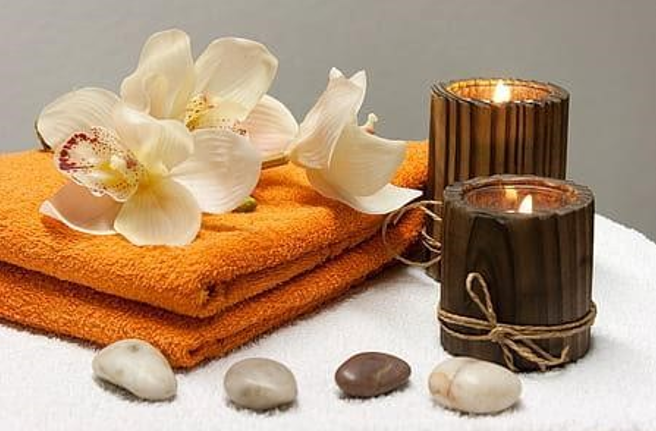 Spa setting with towels, orchids and candles